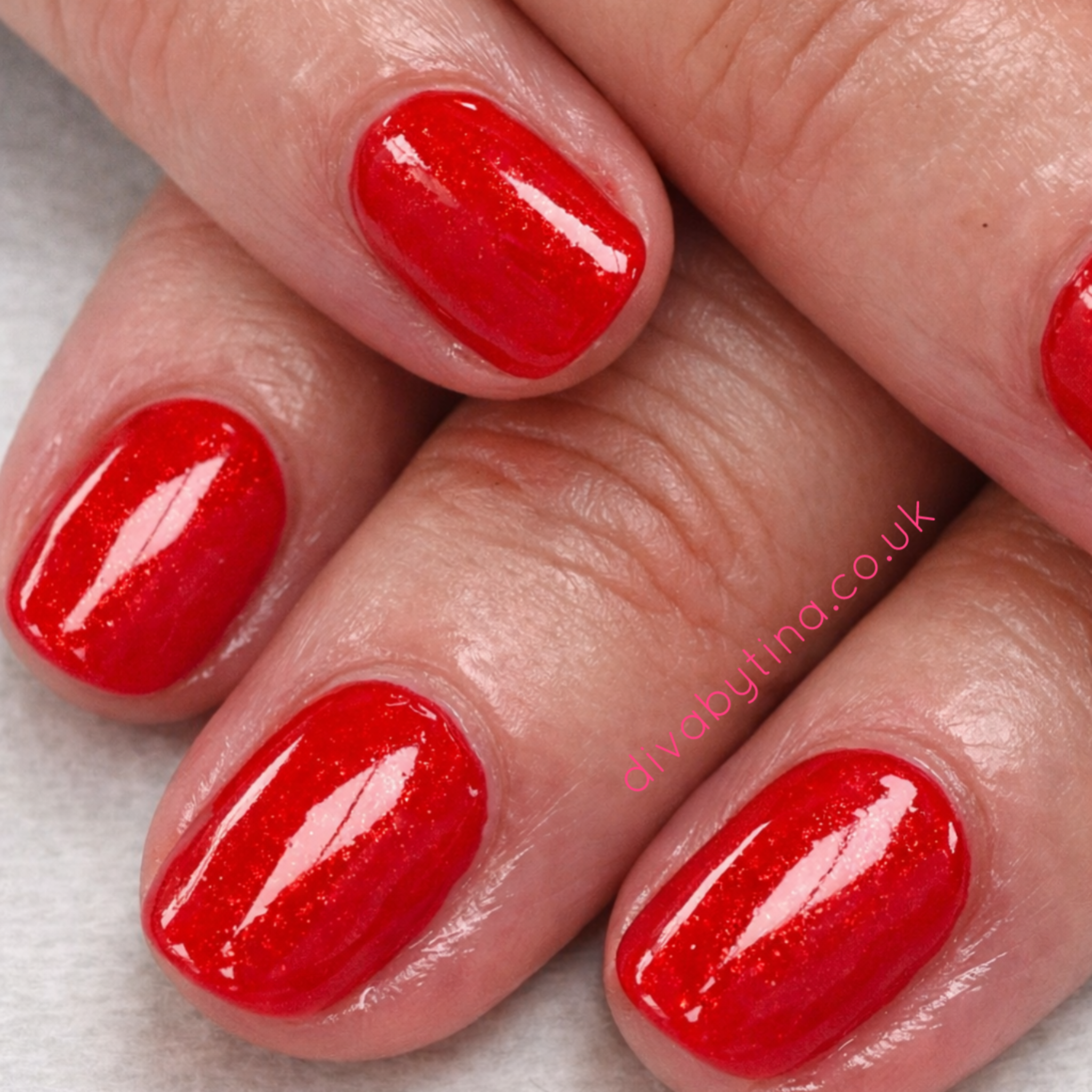 alt="Glossy red gel manicure on short natural nails at a professional nail salon in Liverpool"
