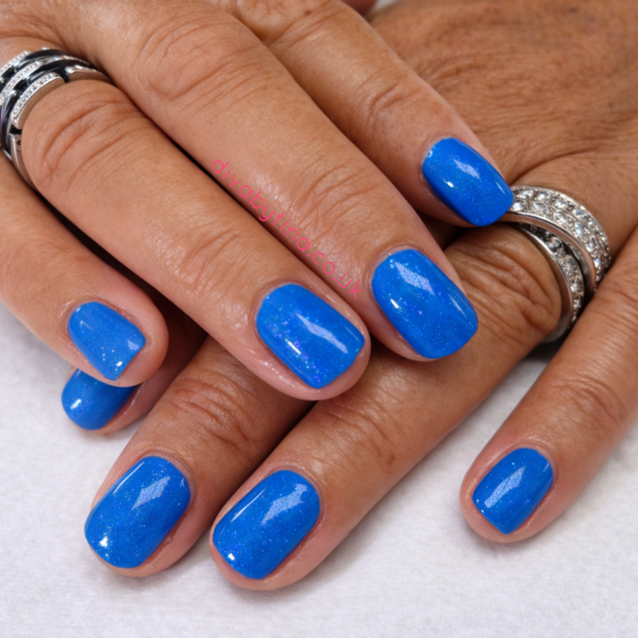 alt="Glossy blue gel manicure on short natural nails at a professional nail salon in Belle Vale, Liverpool"